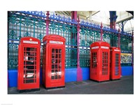 Four telephone booths near a grille, London, England Fine Art Print