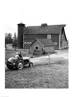 Man with a Boy Riding a Tractor in a Field Fine Art Print