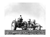 Low Angle View of a Farmer Planting Corn with a Tractor in a Field Fine Art Print