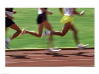 Low section view of male athletes running on a running track Fine Art Print