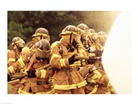 Group of firefighters spraying water with a fire hose Fine Art Print