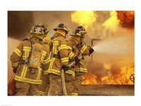Rear view of a group of firefighters extinguishing a fire and flames Fine Art Print