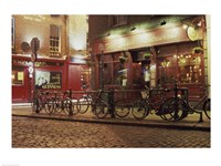 Bicycles parked in front of a restaurant at night, Dublin, Ireland - various sizes