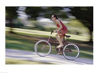Side profile of a young woman riding a bicycle Fine Art Print