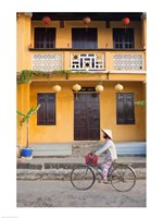 Person riding a bicycle in front of a cafe, Hoi An, Vietnam Fine Art Print