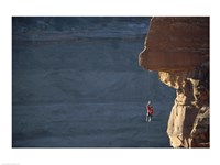 Man hanging from a rope on the edge of a cliff Fine Art Print