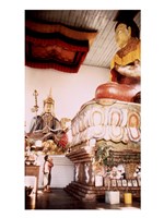 A Young Girl Praying in Front of a Giant Buddha Statue Fine Art Print