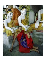 Monk Sitting in Front of a Buddha Statue Fine Art Print