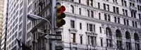 Low angle view of a Red traffic light in front of a building, Wall Street, New York City Fine Art Print