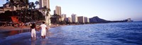 Rear view of a couple wading on the beach, Waikiki Beach, Honolulu, Oahu, Hawaii, USA Fine Art Print