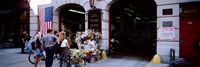 Rear view of three people standing in front of a memorial at a fire station, New York City, New York State, USA Fine Art Print
