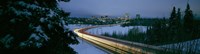 Autumobile lights on busy street, distant city lights, frozen Westchester Lagoon, Anchorage, Alaska, USA. Fine Art Print