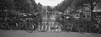 Bicycle Leaning Against A Metal Railing On A Bridge, Amsterdam, Netherlands by Panoramic Images - 27" x 9"