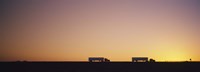 Silhouette of two trucks moving on a highway, Interstate 5, California, USA Fine Art Print