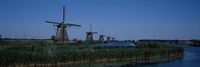 Traditional windmills at a riverbank, Kinderdijk, Rotterdam, Netherlands Fine Art Print