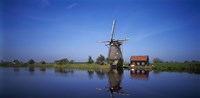 Reflection of a traditional windmill in a lake, Netherlands Fine Art Print