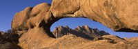 Mountains viewed through a natural arch with a mother holding her baby, Spitzkoppe, Namib Desert, Namibia Fine Art Print