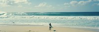 Surfer standing on the beach, North Shore, Oahu, Hawaii by Panoramic Images - 27" x 9"