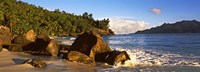 Waves splashing onto rocks on North Island with Silhouette Island in the background, Seychelles Fine Art Print