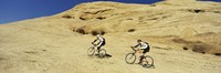Side profile of two men mountain bilking on rocks, Slickrock Trail, Moab, Utah, USA Fine Art Print