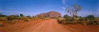 Desert Road And Ayers Rock, Australia Framed Print