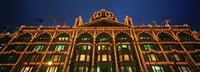 Low angle view of a building lit up at night, Harrods, London, England Fine Art Print