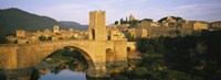 Arch bridge across a river in front of a city, Besalu, Catalonia, Spain Fine Art Print