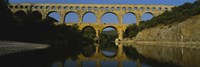 Reflection of an arch bridge in a river, Pont Du Gard, France Fine Art Print