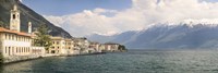Buildings at the waterfront with snowcapped mountain in the background, Gargnano, Monte Baldo, Lake Garda, Lombardy, Italy by Panoramic Images - various sizes