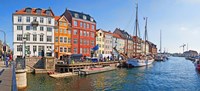 Buildings along a canal with boats, Nyhavn, Copenhagen, Denmark Fine Art Print