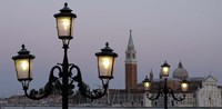 Lampposts lit up at dusk with building in the background, San Giorgio Maggiore, Venice, Italy by Panoramic Images - 16" x 8"