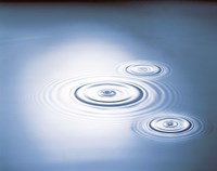 Three rings in grey tinted water with bright light by Panoramic Images - 24" x 19"