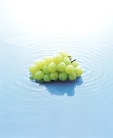 Bunch of Grapes Floating On Water Fine Art Print