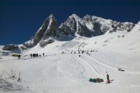 People enjoying snow tubing at Jade Dragon Snow Mountain, Lijiang, Yunnan Province, China Fine Art Print