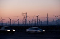 Cars moving on road with wind turbines in background at dusk, Palm Springs, Riverside County, California, USA Fine Art Print