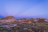 Gibbous moon and crepuscular rays over Dinosaur Provincial Park, Canada Fine Art Print