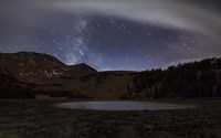 Star trails and the blurred band of the Milky Way above a lake in the Eastern Sierra Nevada Fine Art Print