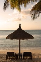 Mauritius, Beach scene, umbrella, chairs, palm fronds Fine Art Print