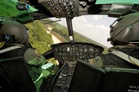 Two instructor pilots practice low flying operations in a UH-1H Huey helicopter Fine Art Print