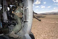 A HH-60G Pave Hawk gunner fires his GAU-17 machine gun Fine Art Print
