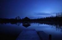 A small pier in a lake against starry sky, Moscow region, Russia Fine Art Print