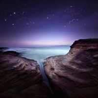 Two large rocks in a sea, against starry sky Fine Art Print