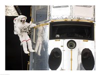 Astronaut performs work on the Hubble Space Telescope Fine Art Print