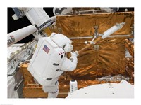 Astronaut works with the Hubble Space Telescope in the cargo bay of Atlantis Fine Art Print