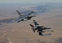 Two F-16's on a training mission over the Arizona desert Fine Art Print