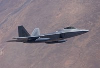 An F-22 Raptor on a Training Mission Fine Art Print
