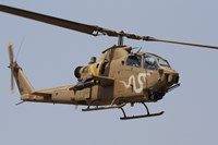 An AH-1S Tzefa helicopter in flight Fine Art Print