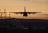 A C-130J Super Hercules Landing at Ramstein Air Base, Germany, at Dusk Fine Art Print