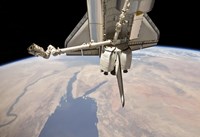 The Aft Section of the Docked Space Shuttle Discovery and the Station's Robotic Canadarm2 Fine Art Print