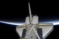 Space Shuttle Discovery Intersecting the Thin line of Earth's Atmosphere, while Docked with the International Space Station Fine Art Print
